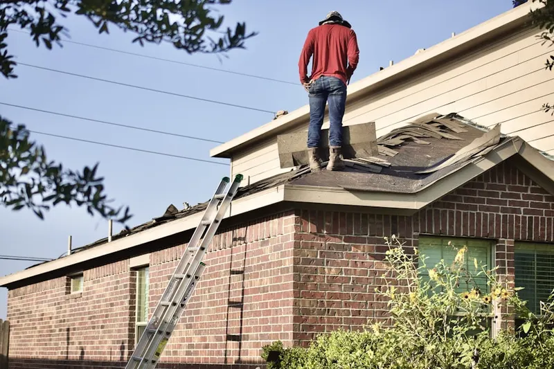 Professional roofer working on a residential roof in North Valley Stream